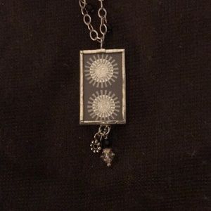 Art necklace on 20” silver chain.